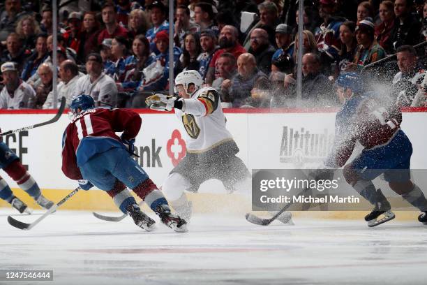 William Carrier of the Vegas Golden Knights skates against Andrew Cogliano and Brad Hunt of the Colorado Avalanche at Ball Arena on February 27, 2023...