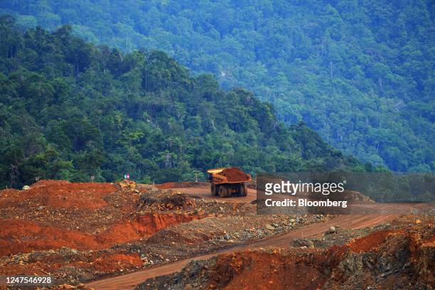 Dump trucks travel along a track at a nickel mine operated by PT Vale Indonesia in Sorowako, South Sulawesi, Indonesia, on Monday, June 13, 2022. The...