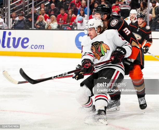 Alex Stalock of the Chicago Blackhawks and John Klingberg of the Anaheim Ducks battle for position during the second period at Honda Center on...