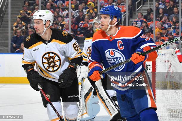 Connor McDavid of the Edmonton Oilers and Dmitry Orlov of the Boston Bruins skate during the game on February 27, 2023 at Rogers Place in Edmonton,...