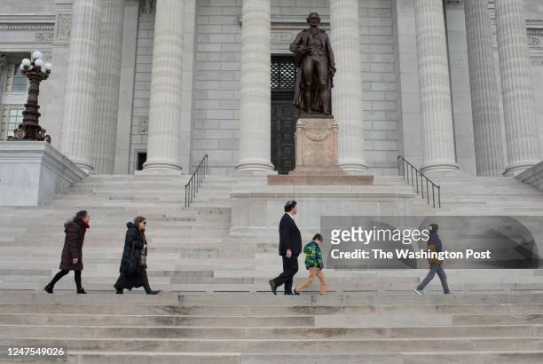 Rabbi Daniel Bogard and his family walk past the columns on the premises of the Missouri State Capitol in Jefferson City, Mo., on Wednesday, February...
