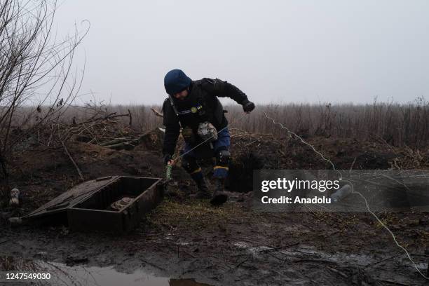 Officers of the Donetsk oblast DSNS demining team work to clear mines and unexploded ordnance from the area outside of Lyman, Ukraine on Feb 27, 2023.