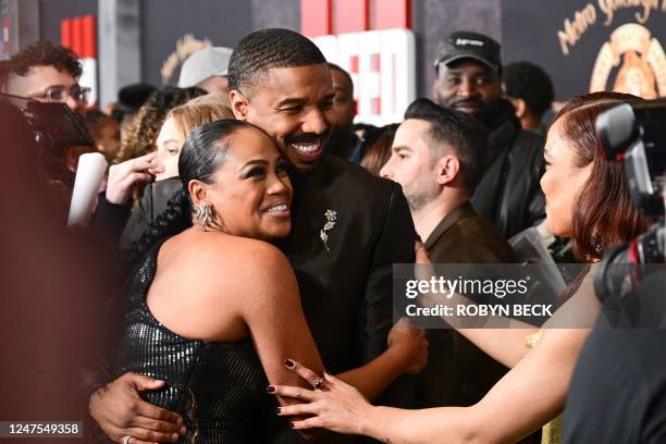 Producer Zinzi Coogler hugs actor-director-producer Michael B. Jordan as they arrive for the Los Angeles premiere of Creed III at the TCL Chinese...