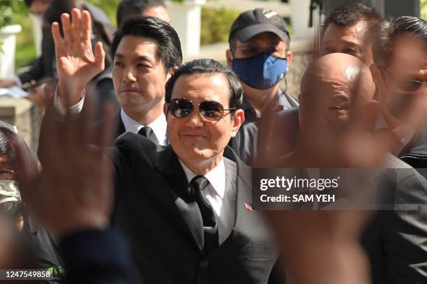 Former president Ma Ying-Jeou waves to relatives as Taipei Mayor Chiang Wan-an follows during a ceremony marking the 76th anniversary of "228...