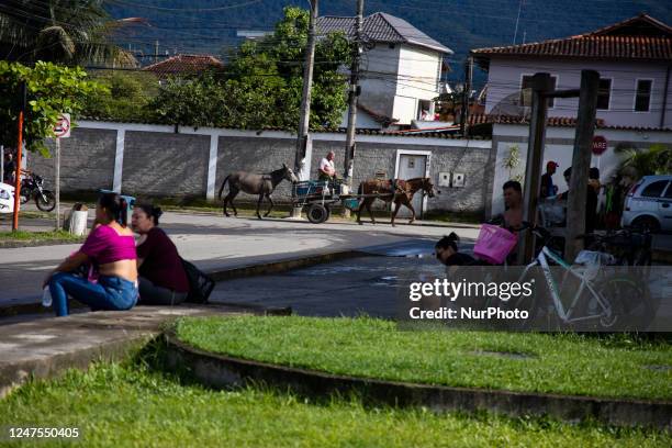 Man transports wares with a cart trained by a horse in Paraty, Rio De Janeiro on February 23, 2023.