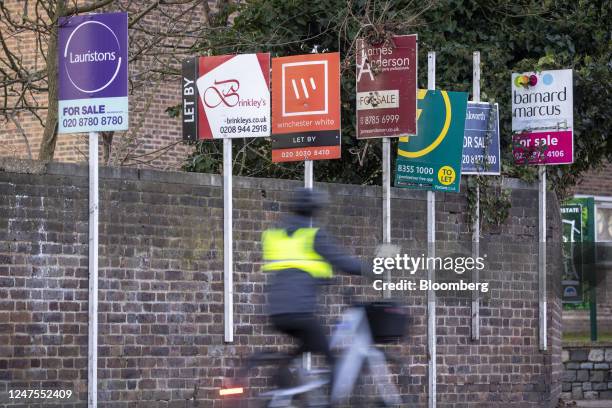 Estate agents "For Sale", "To Let" and "Let By" sign boards outside a block of flats in the Putney district of London, UK, on Monday, Feb. 27, 2023....