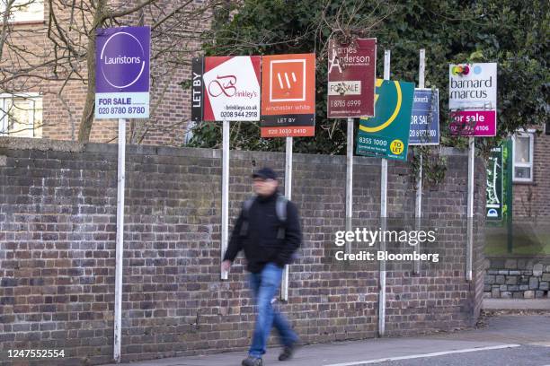 Estate agents "For Sale", "To Let" and "Let By" sign boards outside a block of flats in the Putney district of London, UK, on Monday, Feb. 27, 2023....