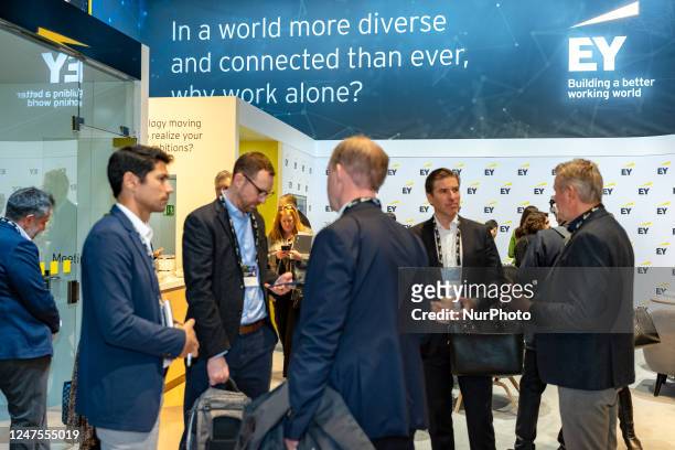 Visitors walk at the EY during the Mobile World Congress 2023 , the telecom industry's biggest annual gathering on February 28, 2023 in Barcelona,...