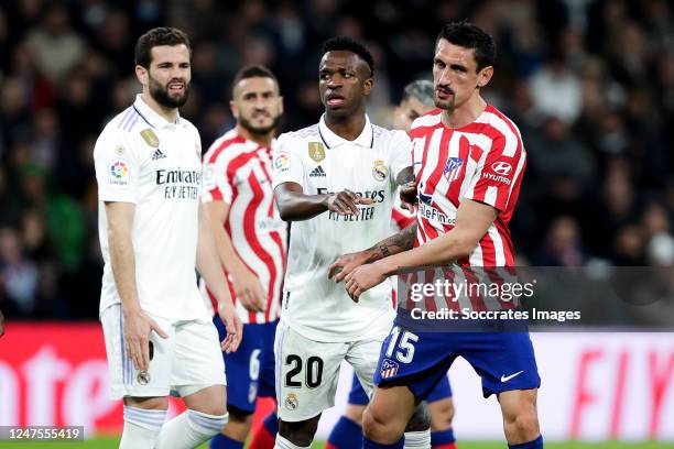 Nacho Fernandez of Real Madrid, Vinicius Junior of Real Madrid and Stefan Savic of Atletico Madrid during the La Liga Santander match between Real...