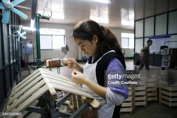 Worker works at a workshop of a silk company in Chongqing, China, February 23, 2023. February 28, 2023., the National Bureau of Statistics released a...