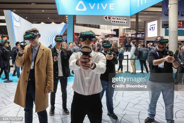 Attendees wear Vive Focus Series virtual reality headsets at the HTC Corp. Stand on day two of the Mobile World Congress at the Fira de Barcelona...