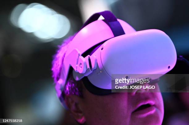 Person tries an Oculus Meta Quest virtual reality headset at the Mobile World Congress , the telecom industry's biggest annual gathering, in...