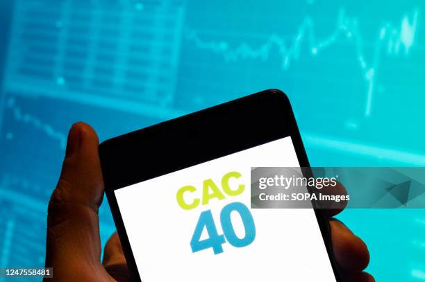 In this photo illustration, the benchmark French stock market index. Cotation Assistée en Continu logo is seen displayed on a smartphone with an...