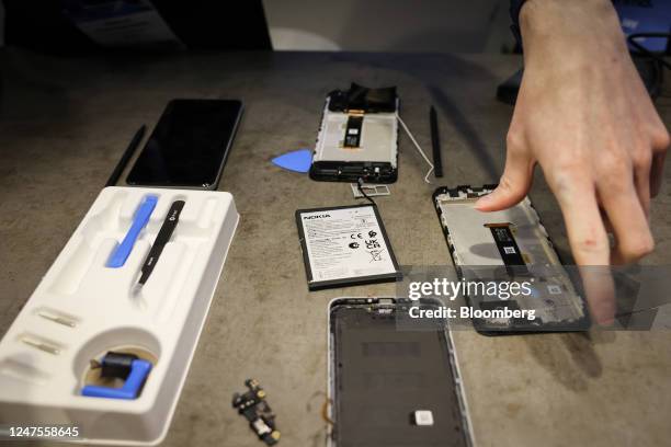 An employee demonstrates a replaceable battery installation into the Nokia G22 smartphone at the Nokia stand on day two of the Mobile World Congress...