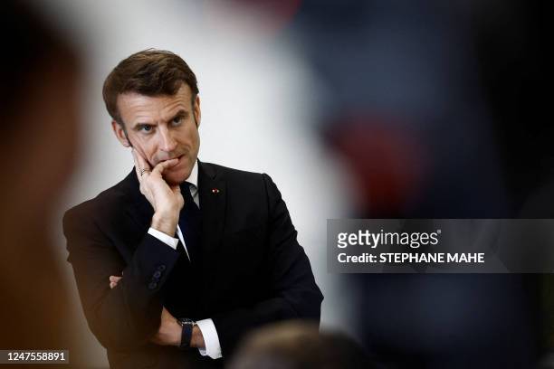 French President Emmanuel Macron gestures as he speaks with schoolchildren in a classroom during a prevention session on the papillomavirus as he...