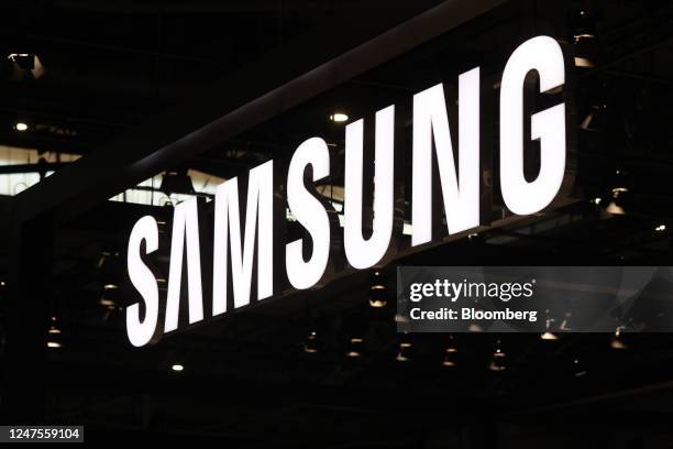 An illuminated logo hangs above the Samsung Electronics Co. Stand on day two of the Mobile World Congress at the Fira de Barcelona venue in...