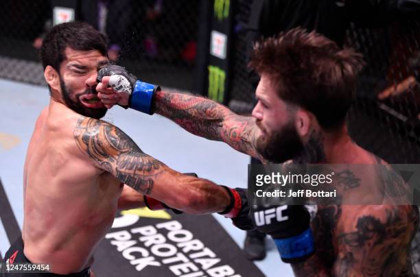 Cody Garbrandt punches Raphael Assuncao of Brazil in their bantamweight bout during the UFC 250 event at UFC APEX on June 06, 2020 in Las Vegas,...