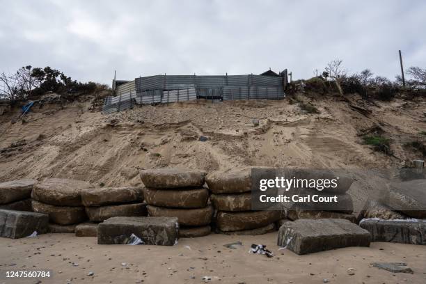 Concrete sea defences are placed on the beach in an attempt to protect a properties after erosion swept away large parts of the sand, on February 28,...