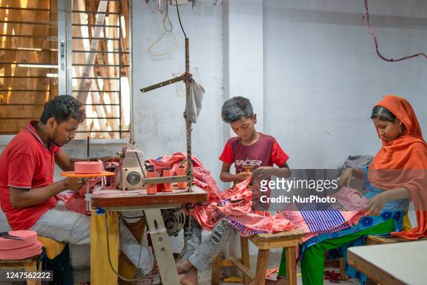 Child labour working with his elderly colleagues in a local garment factory outtake the capital Dhaka, Bangladesh on February 28, 2023.