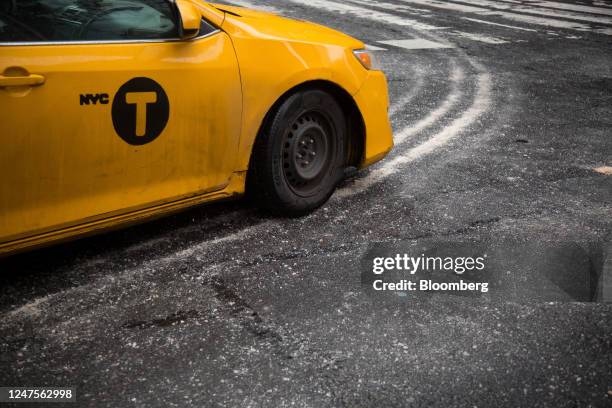 Taxi drives along a salted road following a storm in New York, US, on Tuesday, Feb. 28, 2023. New York City and the Northeast had a slushy start...