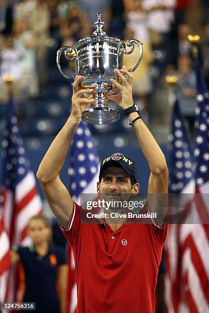 Novak Djokovic of Serbia celebrates with the trophy after he defeated Rafael Nadal of Spain during the Men's Final on Day Fifteen of the 2011 US Open...