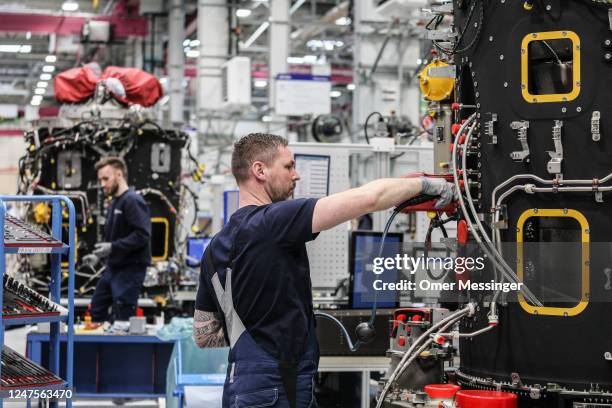 Employees maintains a Rolls-Royce BR700-Nextgen jet engine during a visit of German Labor and Social Affairs Minister Hubertus Heil at the...