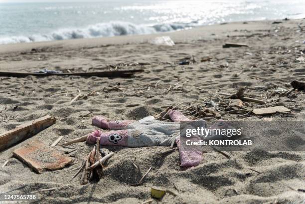 The dress of a little girl who is presumed to have died in the sinking of the migrant boat left among the debris of the boat on the beach where the...