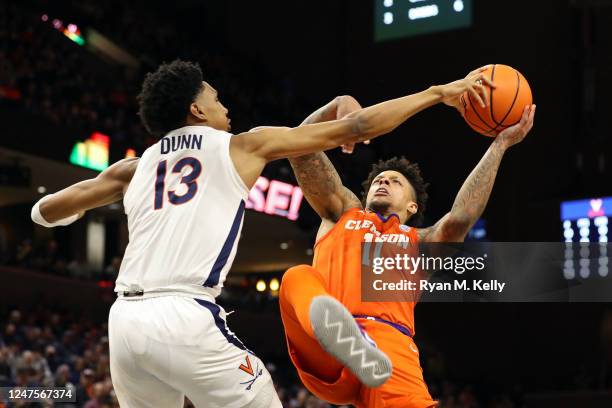 Ryan Dunn of the Virginia Cavaliers blocks a shot by Brevin Galloway of the Clemson Tigers in the first half during a game at John Paul Jones Arena...