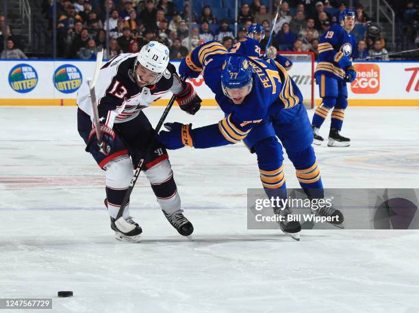 Johnny Gaudreau of the Columbus Blue Jackets and JJ Peterka of the Buffalo Sabres race for the puck during an NHL game on February 28, 2023 at...