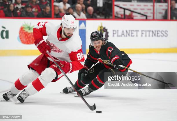 Alex DeBrincat of the Ottawa Senators forechecks against Jake Walman of the Detroit Red Wings at Canadian Tire Centre on February 28, 2023 in Ottawa,...