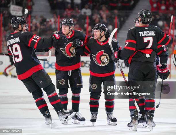 Alex DeBrincat of the Ottawa Senators celebrates his first period goal against the Detroit Red Wings with teammates at Canadian Tire Centre on...