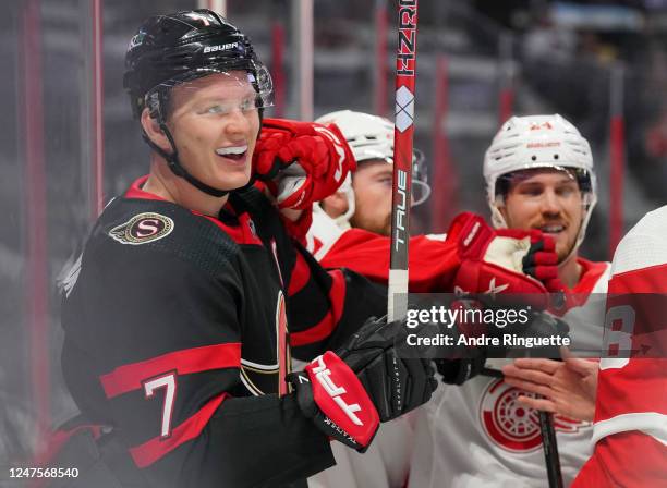 Brady Tkachuk of the Ottawa Senators smiles as he exchanges pushes with Pius Suter of the Detroit Red Wings at Canadian Tire Centre on February 28,...