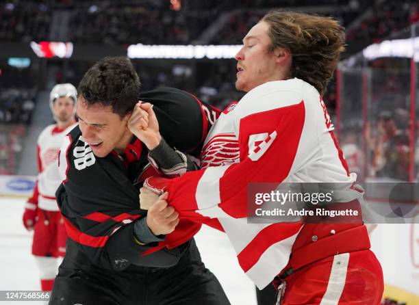 Artem Zub of the Ottawa Senators fights with Tyler Bertuzzi of the Detroit Red Wings at Canadian Tire Centre on February 28, 2023 in Ottawa, Ontario,...