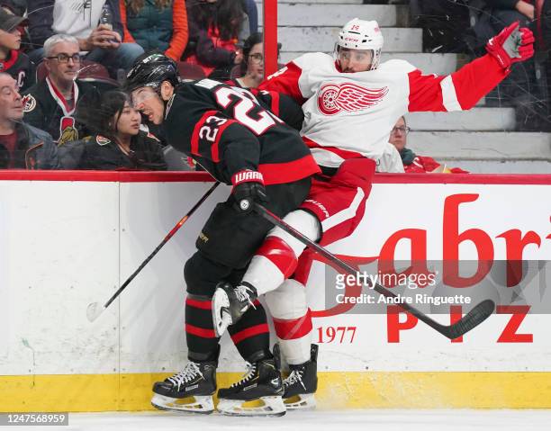 Travis Hamonic of the Ottawa Senators battles for position against Robby Fabbri of the Detroit Red Wings at Canadian Tire Centre on February 28, 2023...