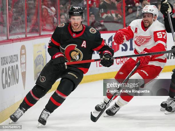 Thomas Chabot of the Ottawa Senators battles for position against David Perron of the Detroit Red Wings at Canadian Tire Centre on February 28, 2023...