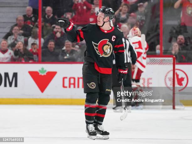 Brady Tkachuk of the Ottawa Senators points to has words with a member of the Detroit Red Wings after a goal scored his teammate Claude Giroux at...