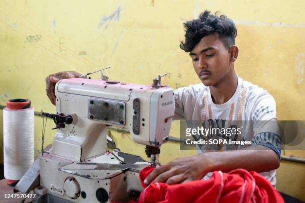 Teenage boy is seen working in a local ready-made garment factory. Child labour is restricted in ready-made garment sectors. However, there are still...