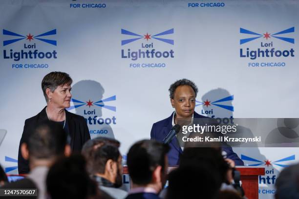 Chicago Mayor Lori Lightfoot speaks as her wife Amy Eshleman looks on at an election night rally at Mid-America Carpenters Regional Council on...
