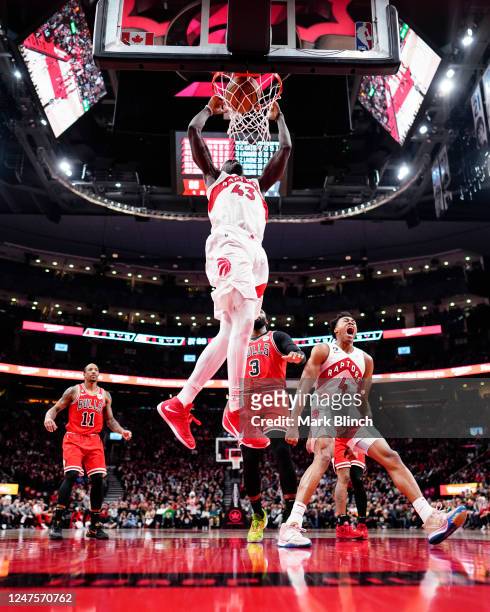 Pascal Siakam of the Toronto Raptors goes up for a dunk as Scottie Barnes celebrates against the Chicago Bulls during the second half of their...