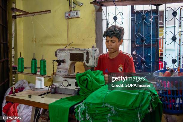 Kid working in a local ready-made garment factory. Child labour is restricted in ready-made garment sectors. However, there are still children...