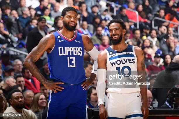 Paul George of the LA Clippers talks with Mike Conley of the Minnesota Timberwolves during the game on February 28, 2023 at Crypto.Com Arena in Los...
