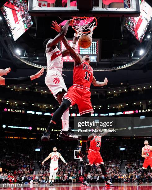 Anunoby of the Toronto Raptors dunks against DeMar DeRozan of the Chicago Bulls during the second half of their basketball game at the Scotiabank...