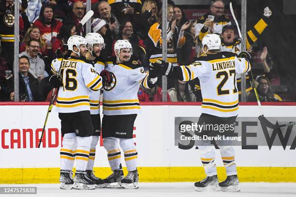 Pavel Zacha of the Boston Bruins celebrates with his team after scoring in the third period against the Calgary Flames to force overtime during an...