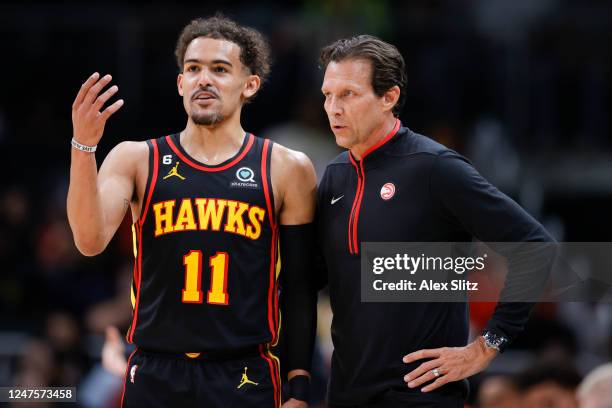 Trae Young of the Atlanta Hawks speaks with Head coach Quin Snyder on the court against the Washington Wizards during the first half at State Farm...