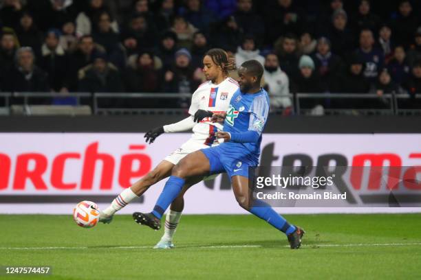 Bradley BARCOLA of Lyon and Jordy GASPAR of Grenoble during the French Cup Quarter-Final match between Lyon and Grenoble at Groupama Stadium on...