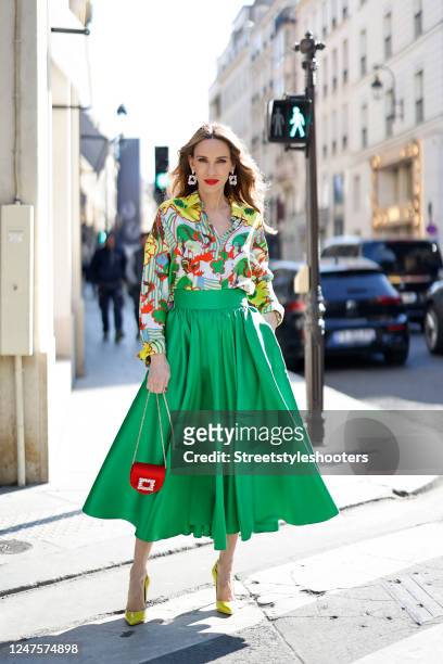 Alexandra Lapp is seen wearing ODEEH blouse, C.WIRSCHKE green satin skirt, CHRISTIAN LOUBOUTIN Hot Chick pumps in yellow, HERMES Kelly bag during a...