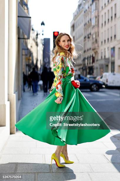 Alexandra Lapp is seen wearing ODEEH blouse, C.WIRSCHKE green satin skirt, CHRISTIAN LOUBOUTIN Hot Chick pumps in yellow, HERMES Kelly bag during a...