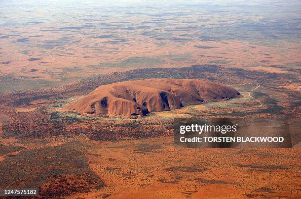 Uluru Ridges The arkose massif of Uluru rises 348 metres above the surrounding ...