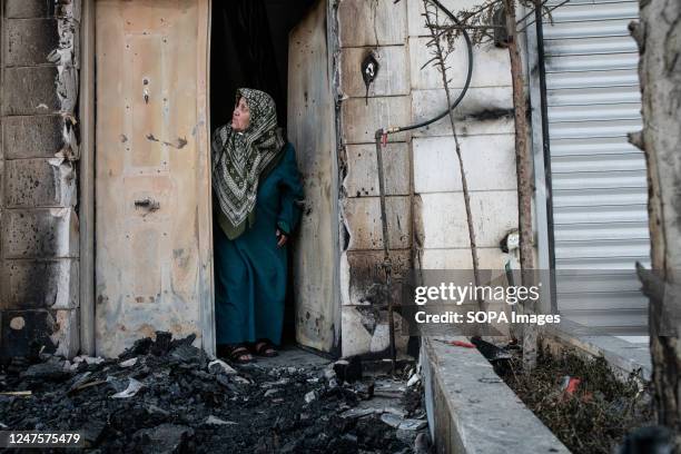 Palestinian elderly woman at her house with its burned doorway which was set on fire by Jewish settlers. Following a terror attack on Sunday in which...