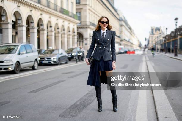 Alexandra Lapp is seen wearing VIVIEN SOPHIE Silver Buckle overknee VIVI® in black, BALMAIN pinstripe blazer in grey, ZARA tie in black, Jil Sander...